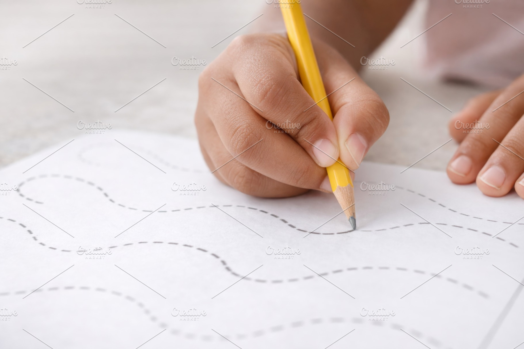 Child practicing handwriting on educ, a Photo by Dvoevnore photos