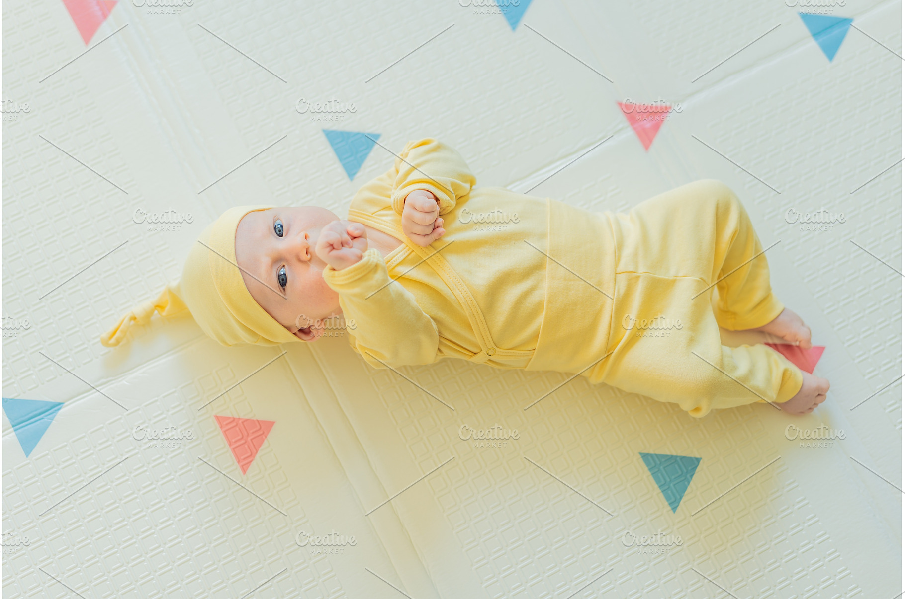 Adorable baby in a yellow hat lying, a Person Photo by Elizaveta Galitskaya
