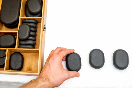 Hot stones for massage in a wooden, a Health & Medical Photo by okskukuruza