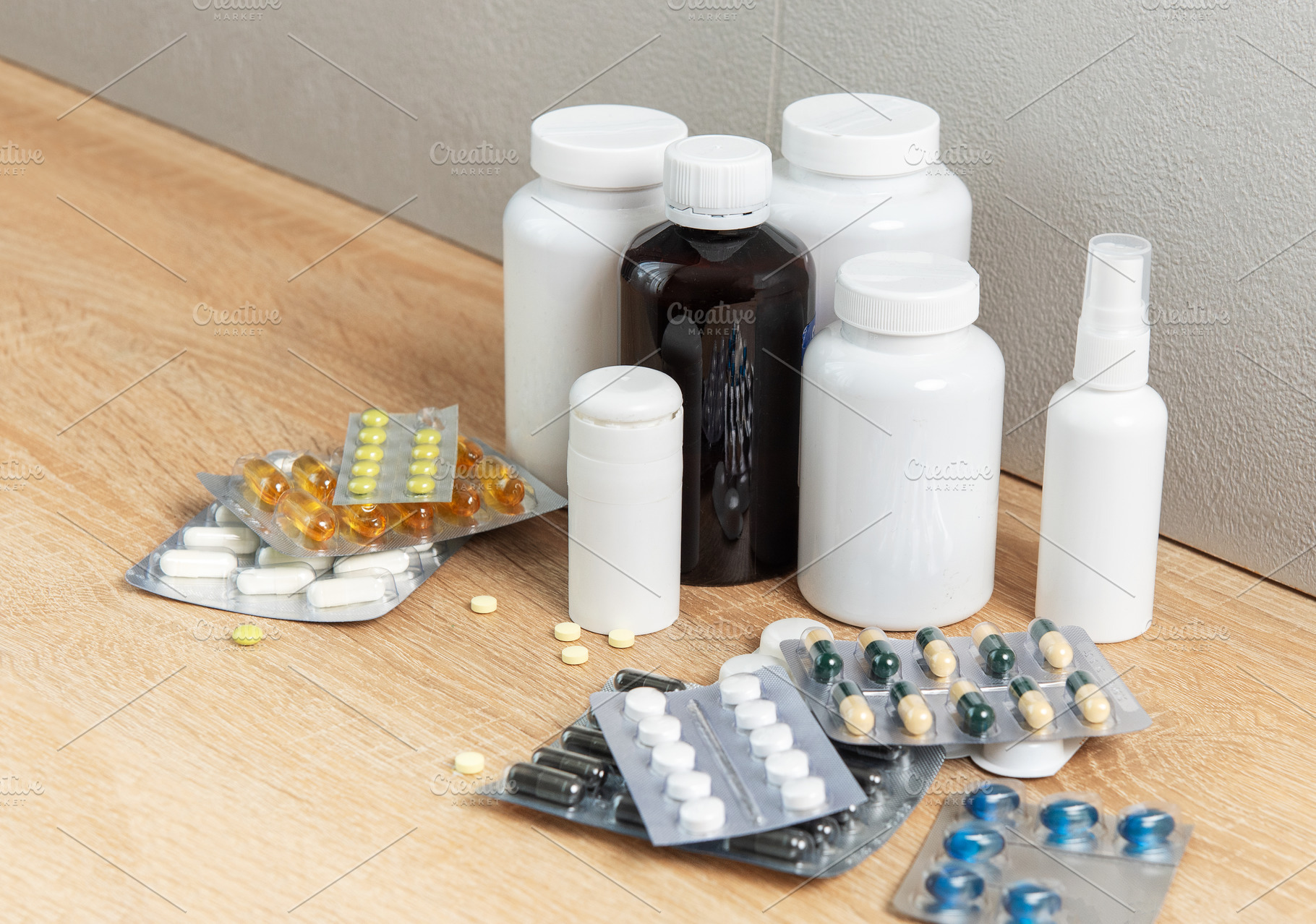 Medicine bottles and blister packs with various pills on wood, a Health & Medical Photo by Olena Rudo