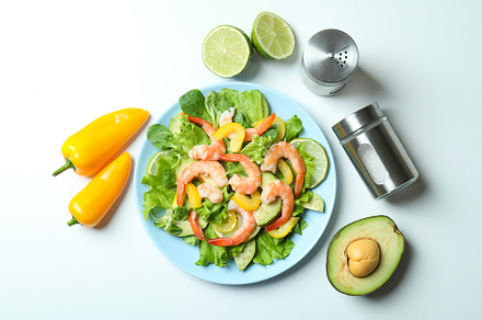 Concept of tasty eating with shrimp salad on white background, a Food & Drink Photo by AtlasStudio PRO