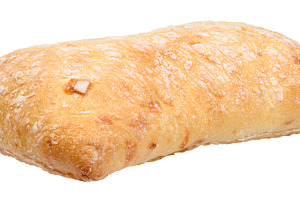 Fresh, crispy ciabatta with a golden crust and flour, close-up
