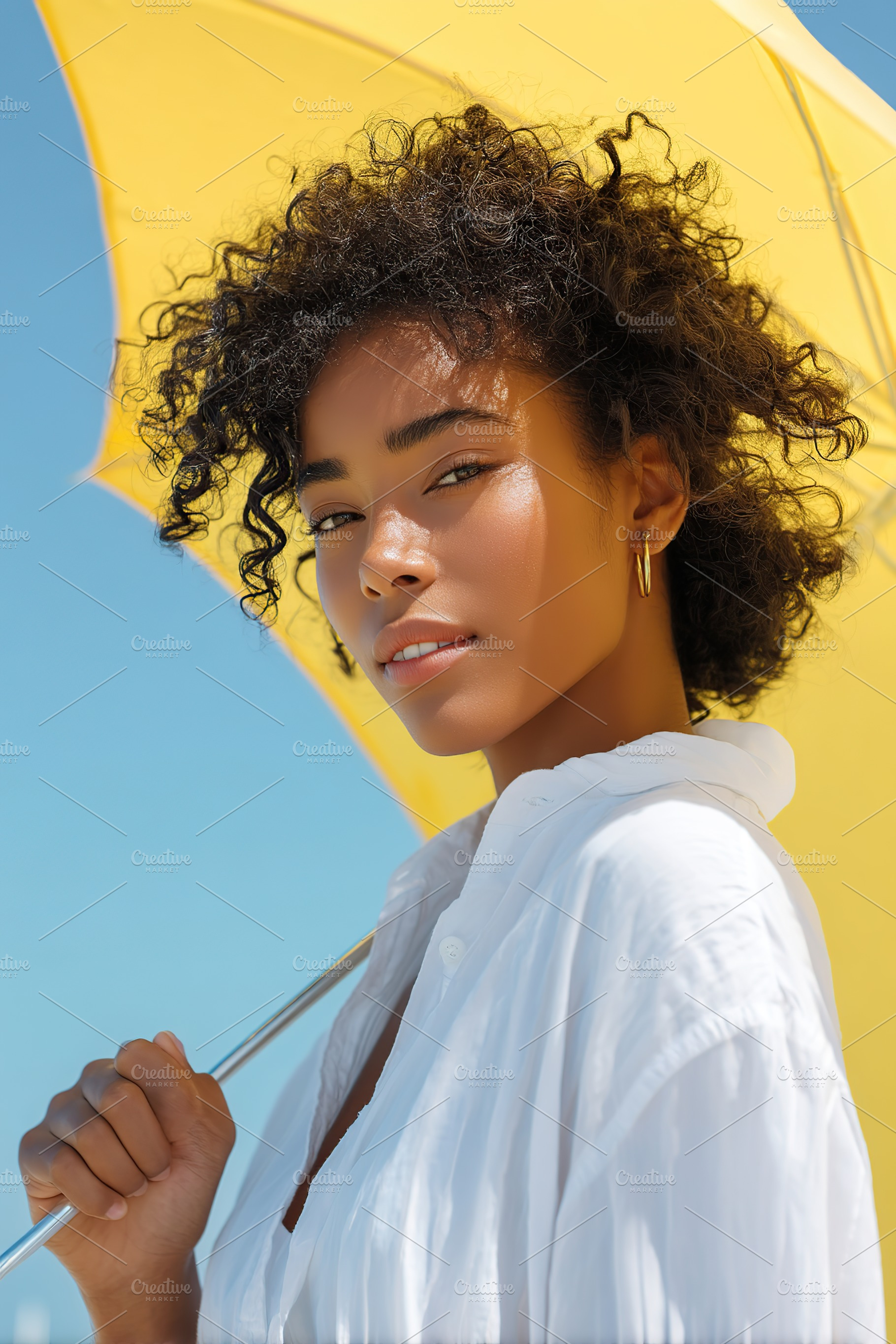 African woman enjoying a sunny day under a yellow umbrella at the beach, a Person Photo by AlyaAnd