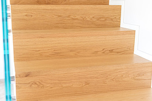 Modern oak staircase with glass balustrade enhancing home interior, an Architecture Photo by Antonio Gravante Market