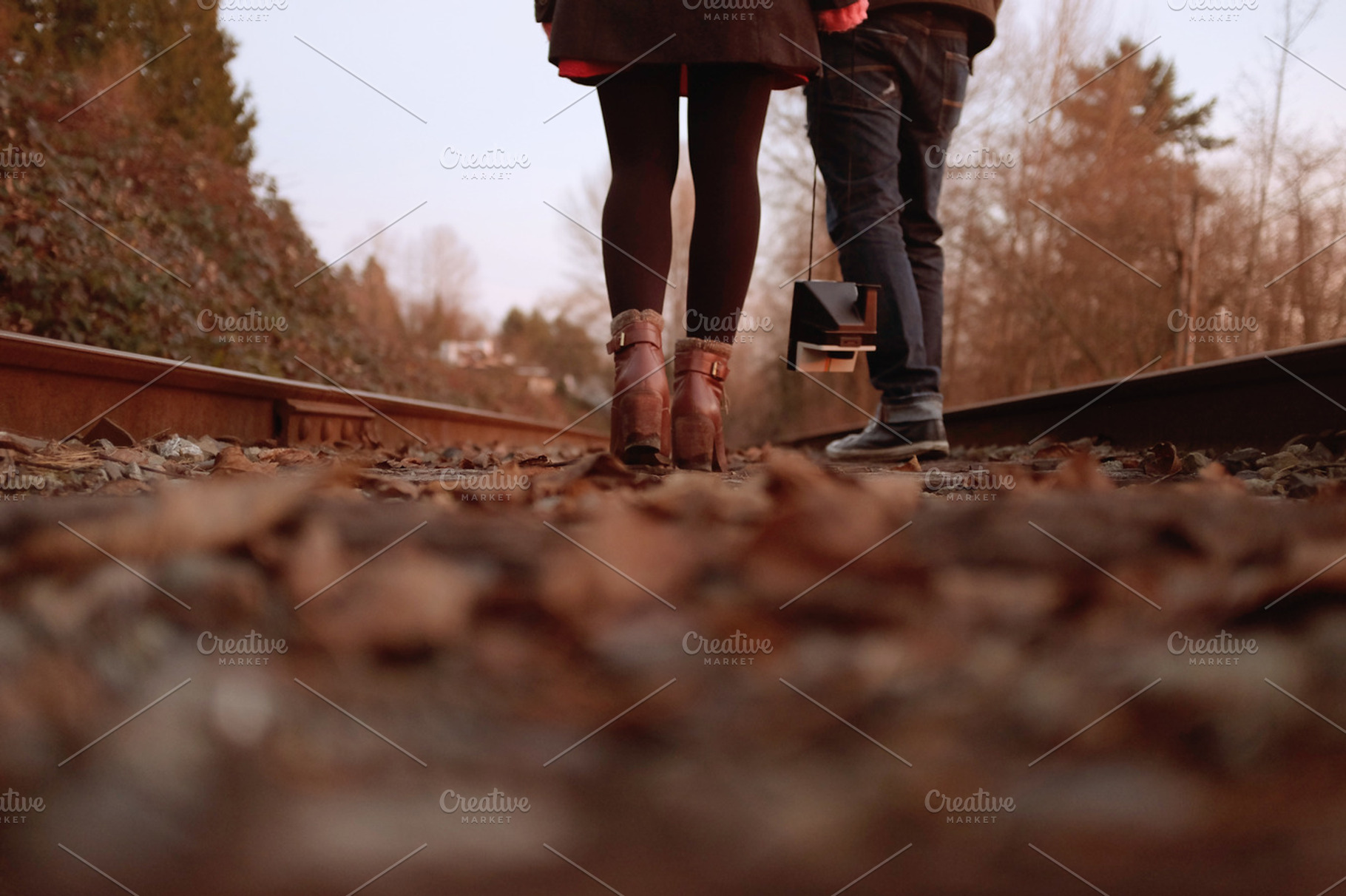 Couple walking on railway tracks #2