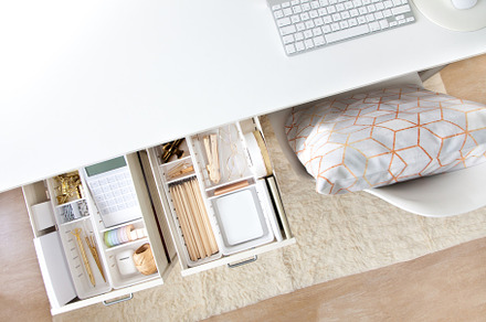 Female white workplace. A method for storing stationery neatly.