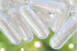 Transparent capsules with green, a Health & Medical Photo by Lermont51