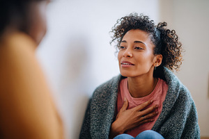 Woman practicing mindfulness in a cozy setting, a Health & Medical Photo by AlyaAnd