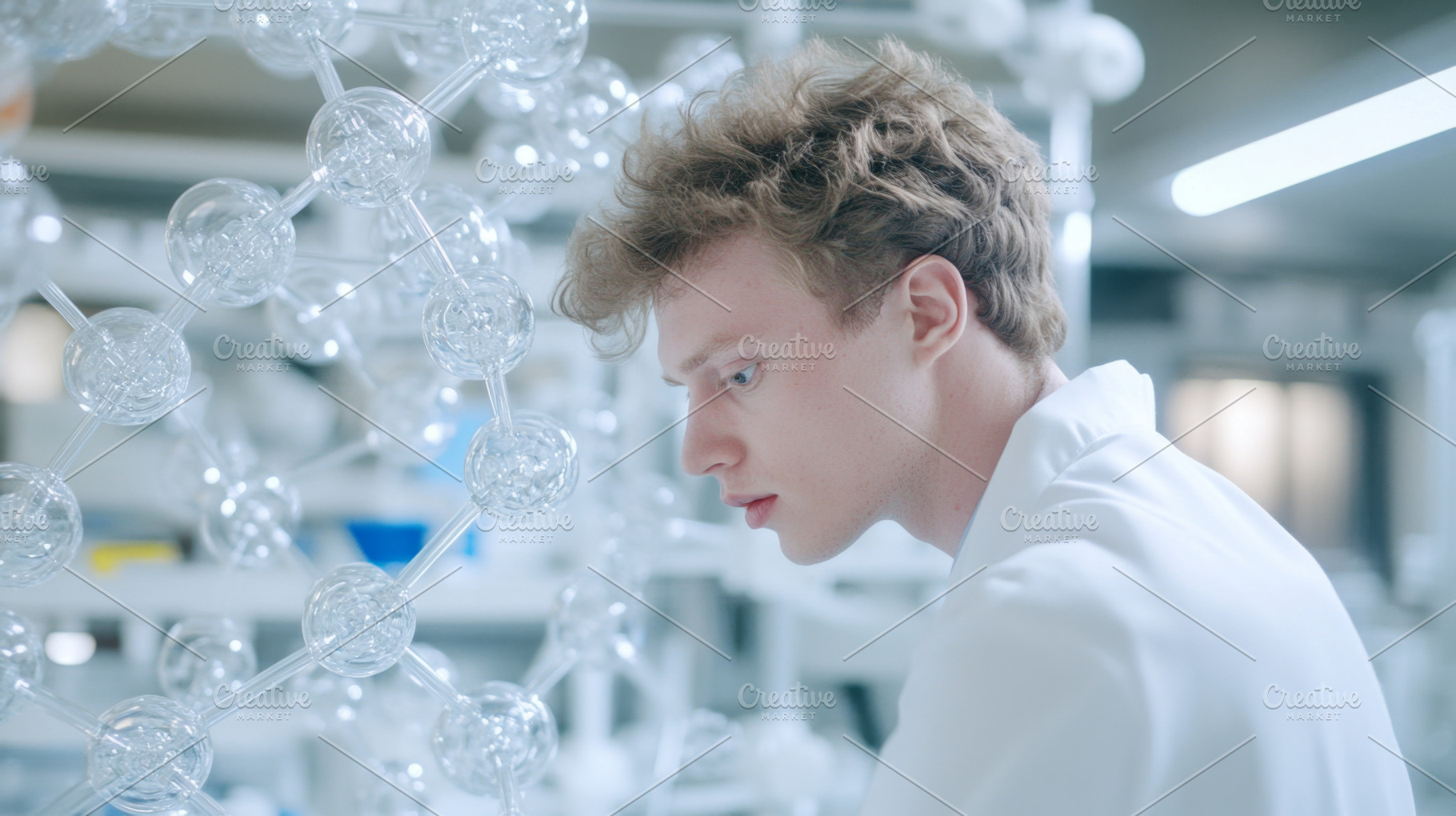 Male medical researcher analyzing mo, a Photo by Dvoevnore photos