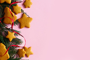 Christmas background with gingerbread cookies, fir branches and, a Photo by Sonjachni