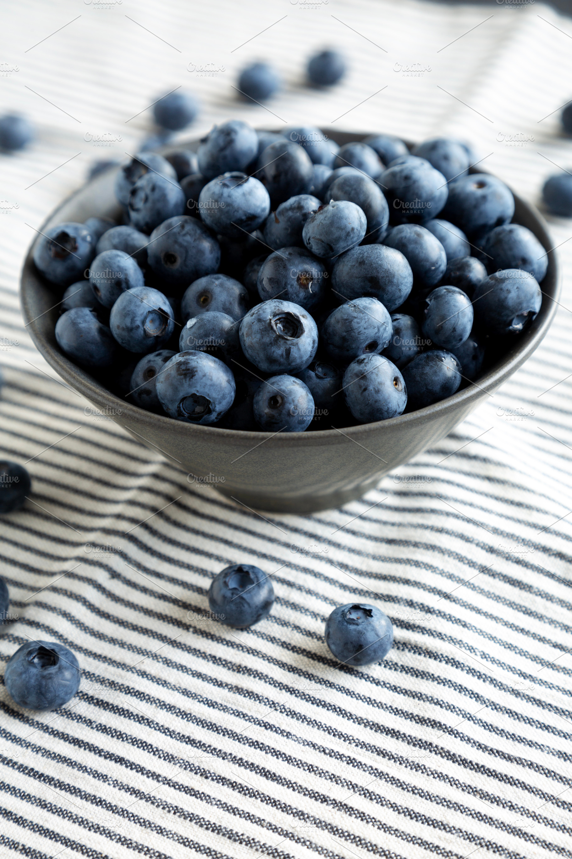 Raw Organic Blueberries in a Bowl, side view., a Food & Drink Photo by LiudmylaChuhunova