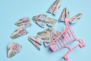 A pink metal shopping cart with scattered paper airplanes on a b, a Business Photo by ndanko