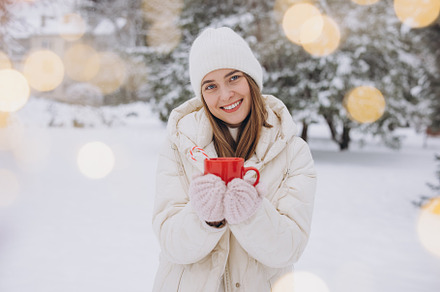 Cute happy woman holding hot coffee, a Holiday Photo by Cherkas Photography