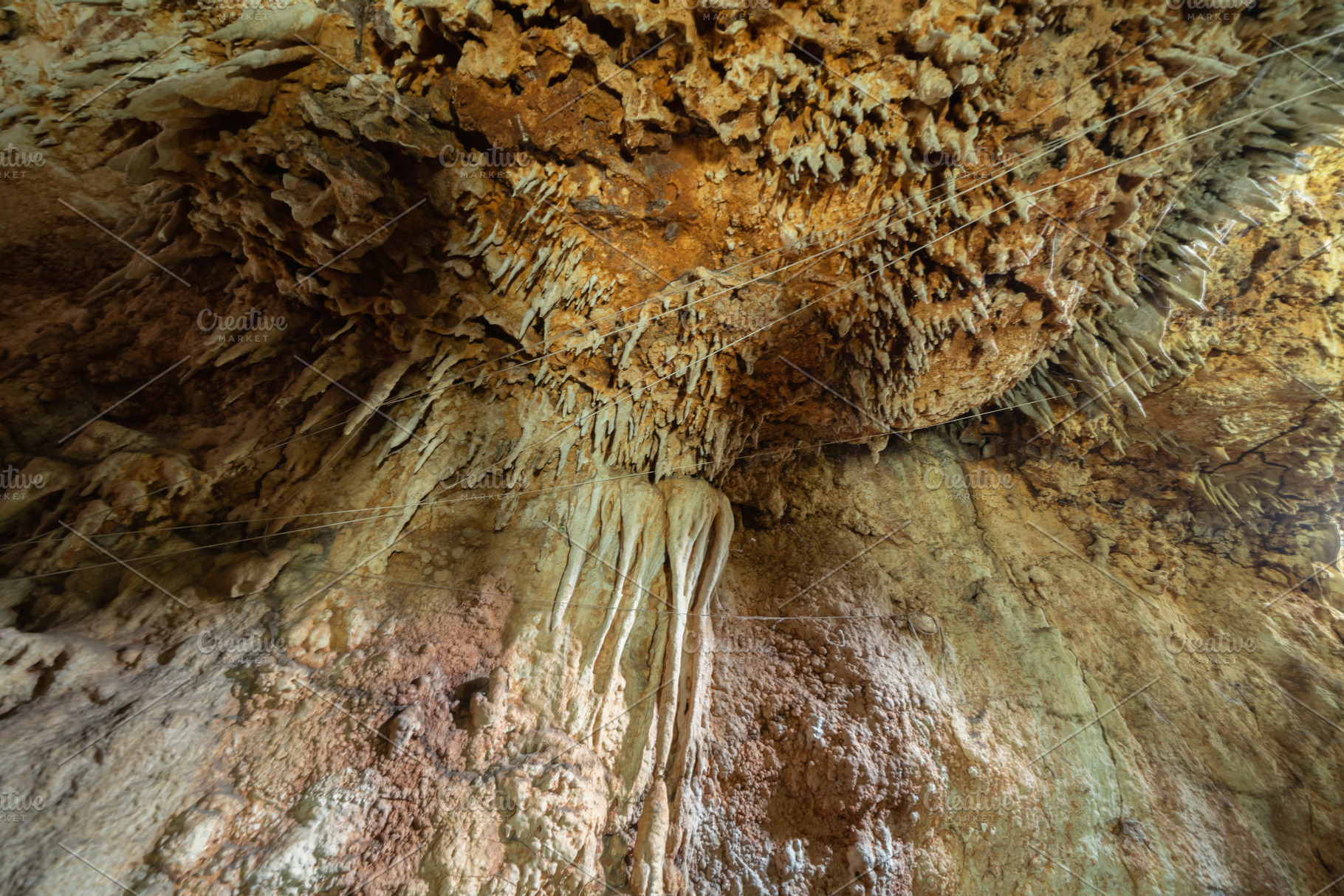 Natural stalactite and stalagmite rock stone cliff hang from cav, a Background Photo by Tampatra