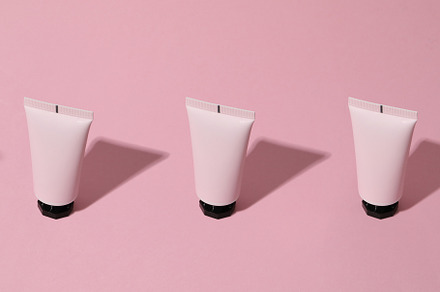 Tube of cosmetic on pink background, space for text, a Beauty & Fashion Photo by AtlasStudio PRO
