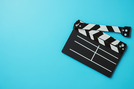 Film clapperboard on vibrant blue ba, a Photo by Iftikhar Alam