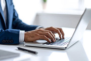 Businessman in suit working on laptop at modern desk, a Business Photo by GoodGoods (Thumbnail 2 of 2)
