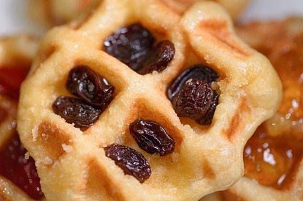 Close up fresh waffles with above dried raisins