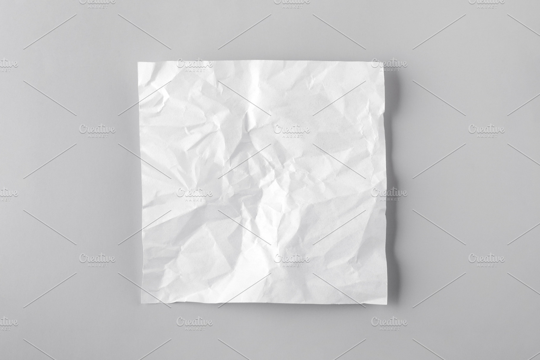 Square crumpled white paper on a clean gray background, top view, a Background Photo by Ales Munt