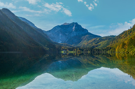 Peaceful autumn Alps mountain lake with clear transparent water, a Nature Photo by YuriyB