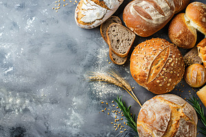 Freshly different baked bread on grey background, a Food & Drink Photo by AlyaAnd