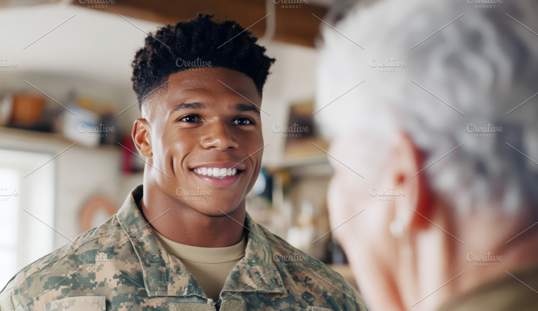 Young african american soldier smiling at elderly woman in cozy, a Photo by Dvoevnore photos