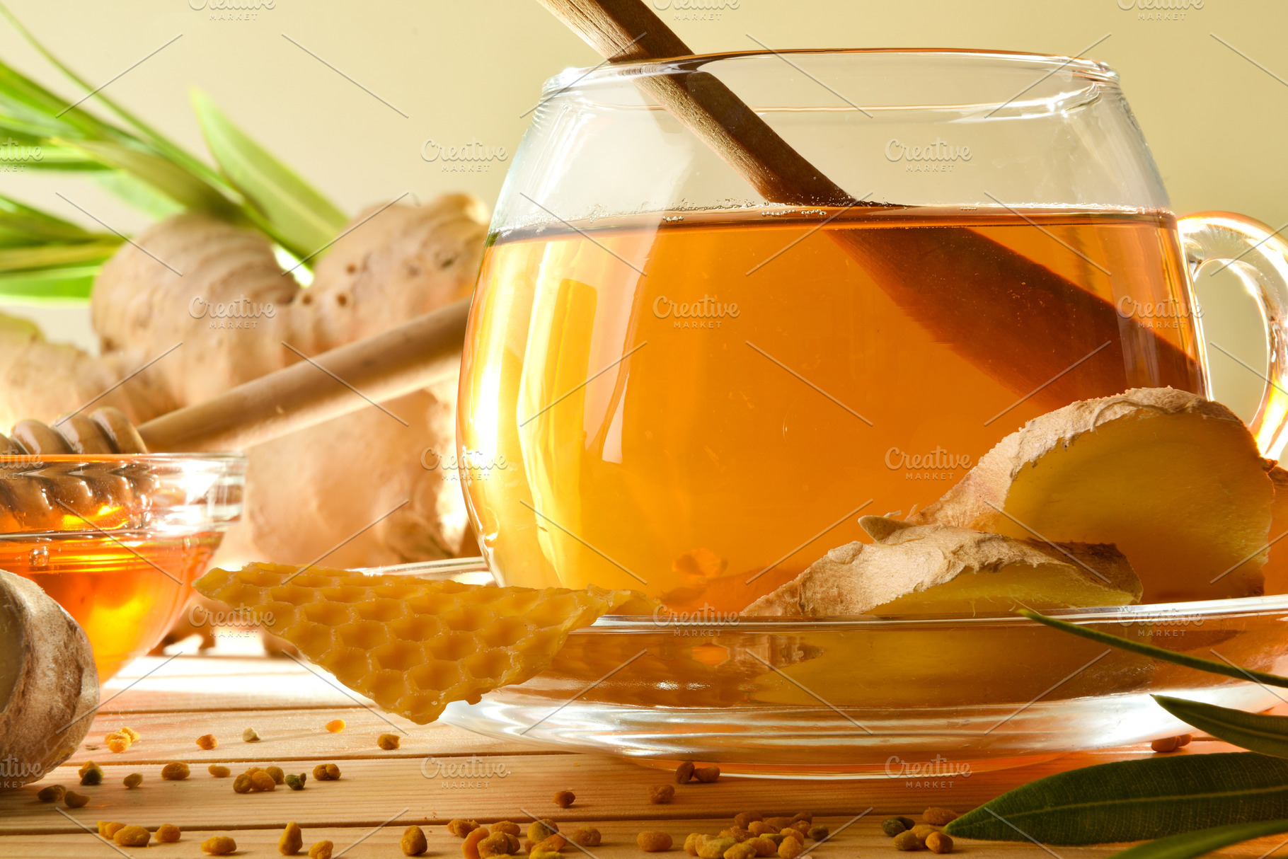 Detail of cup with ginger root and honey on wooden, a Food & Drink Photo by Davizro's Market