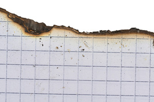 Sheet of white squared notebook paper with a badly burnt top edg, an Abstract Photo by ndanko