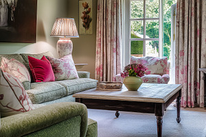 Traditional living room interior with floral prints, cozy furniture, and natura, an Architecture Photo by Studio ANNA