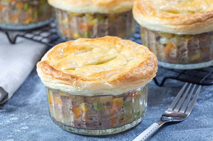 Individual beef pot pies or deep dish pies in ramekin and on cooling rack, hori, a Food & Drink Photo by iuliia_n