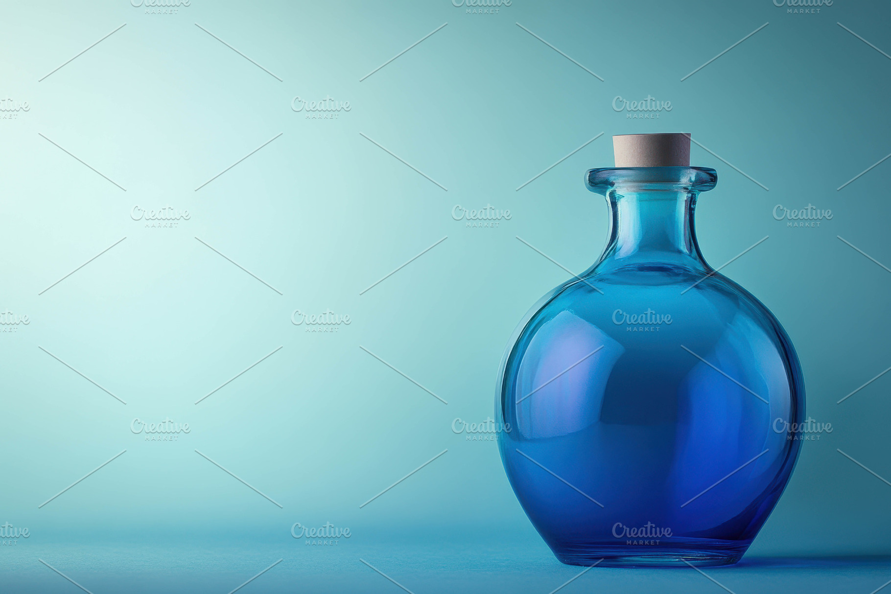 Elegant glass bottle containing blue, a Photo by Tanuart