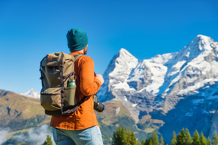 Tourist with a backpack in mountains, a Person Photo by Landscape and travel