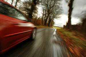 Fast car navigating a winding countr, a Photo by Iftikhar Alam