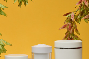 Three white cosmetic jars without labels stand on a white backgr, a Food & Drink Photo by ndanko