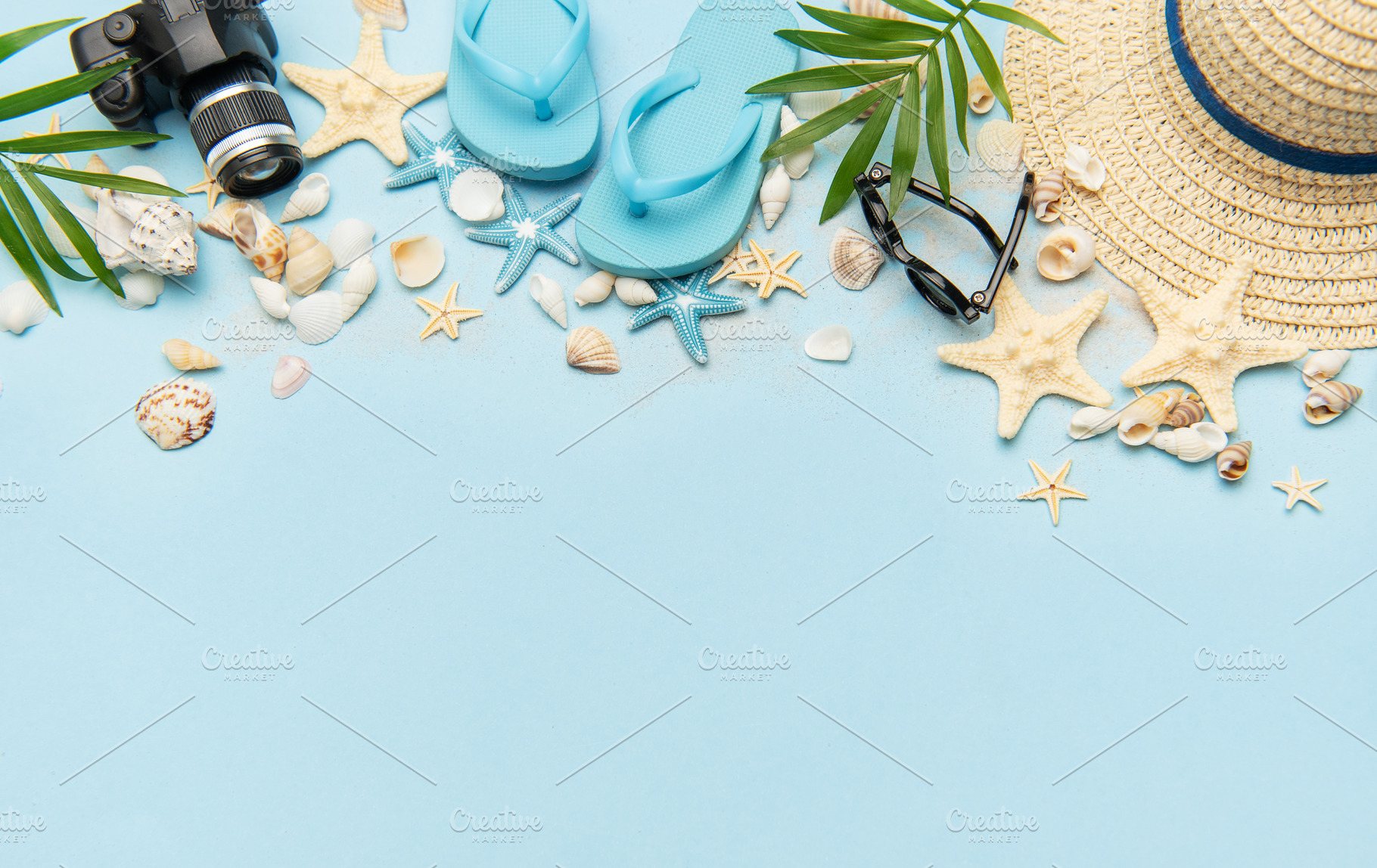 Summer accessories creating a frame on light blue background wit, a Holiday Photo by Olena Rudo