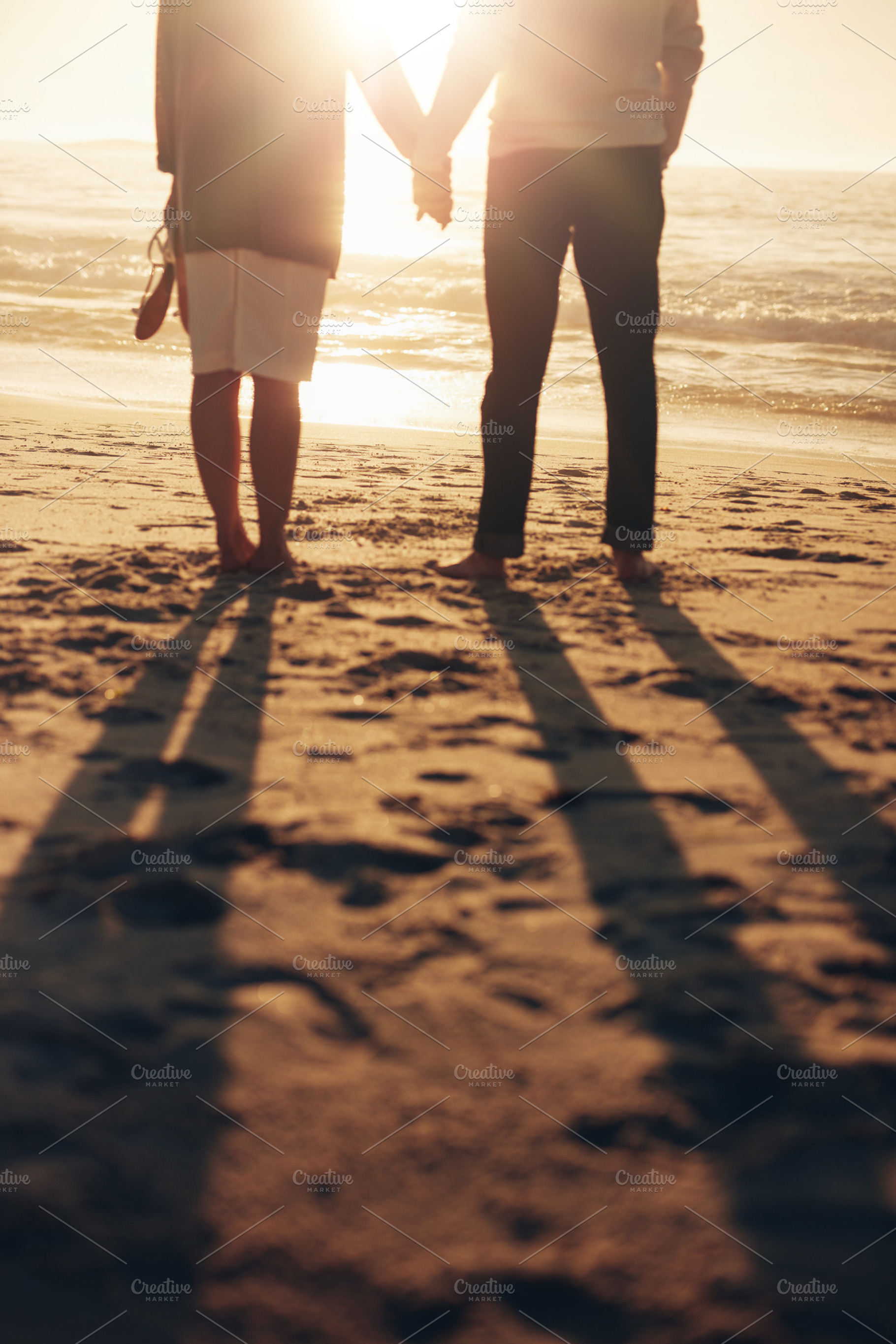 Senior couple holding hands featuring adult, affectionate, and beach, a Person Photo by Jacob Lund