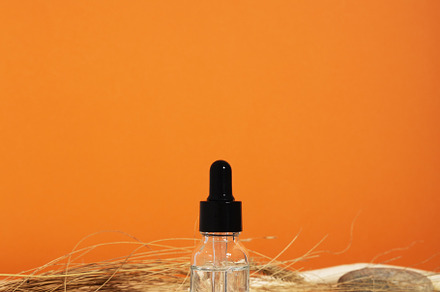 Bottle white glass with dropper on orange background. Natural co, a Beauty & Fashion Photo by matucha