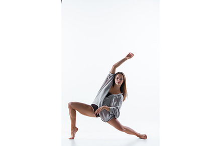Young beautiful dancer in beige dress dancing on white background containing, a Sports & Recreation Photo by Volodymyr Melnyk