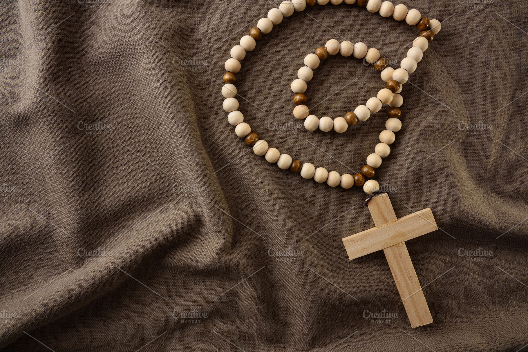 Wooden Rosary with Cross on Fabric Background, a Holiday Photo by Davizro's Market