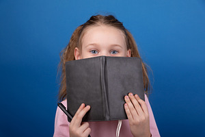 Curious Girl with Notebook, a Person Photo by Ales Munt