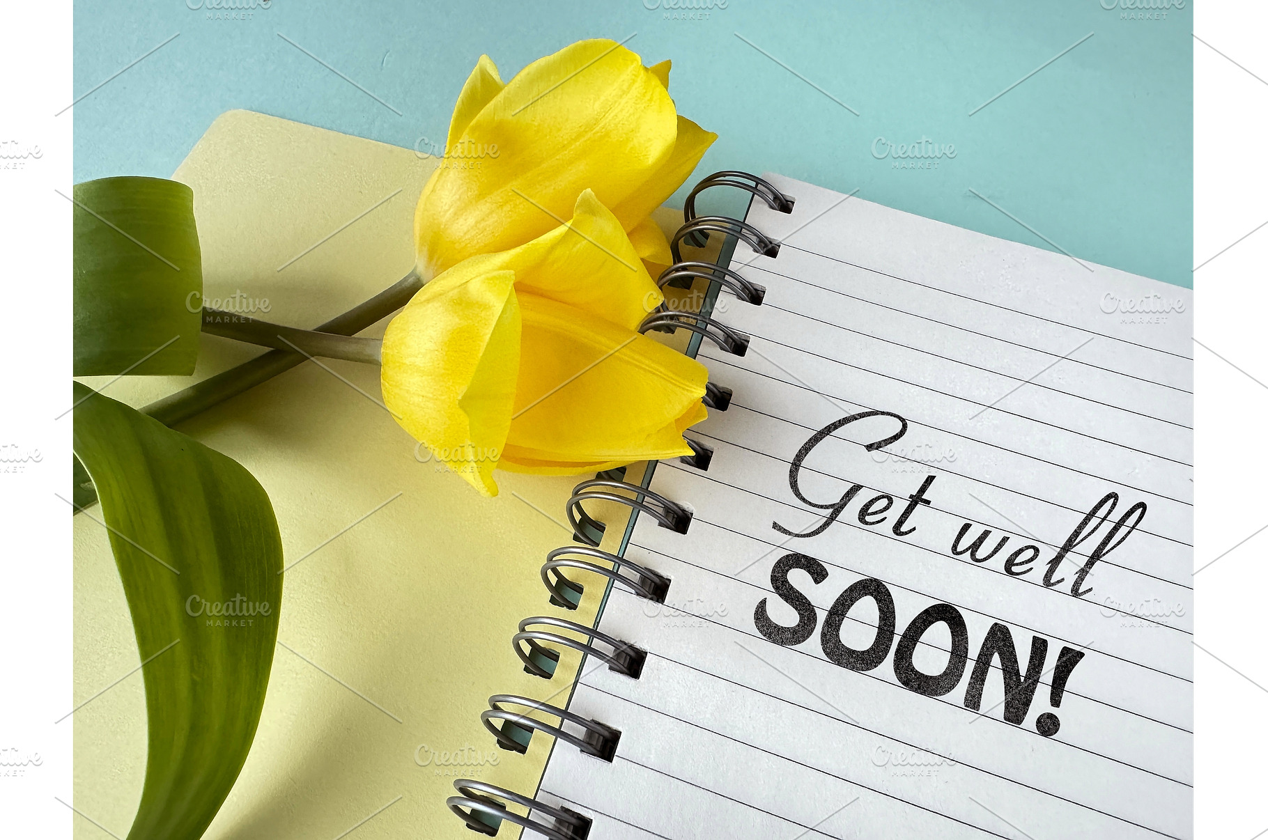 Yellow tulips on a notebook with, a Photo by tilialucida