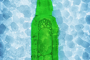 Green beer bottle buried on pile of ice cubes backlit, a Food & Drink Photo by Davizro's Market