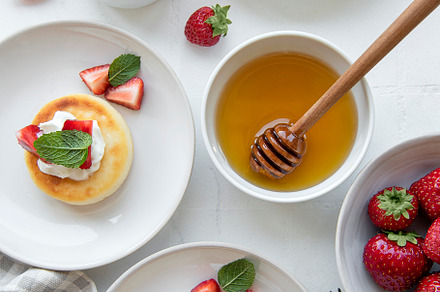 Cottage cheese pancakes, ricotta fritters on ceramic plate with, a Food & Drink Photo by Olena Rudo