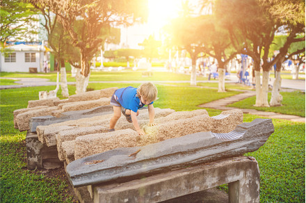 Cute blond boy climbs up the stone, a Nature Photo by Elizaveta Galitskaya