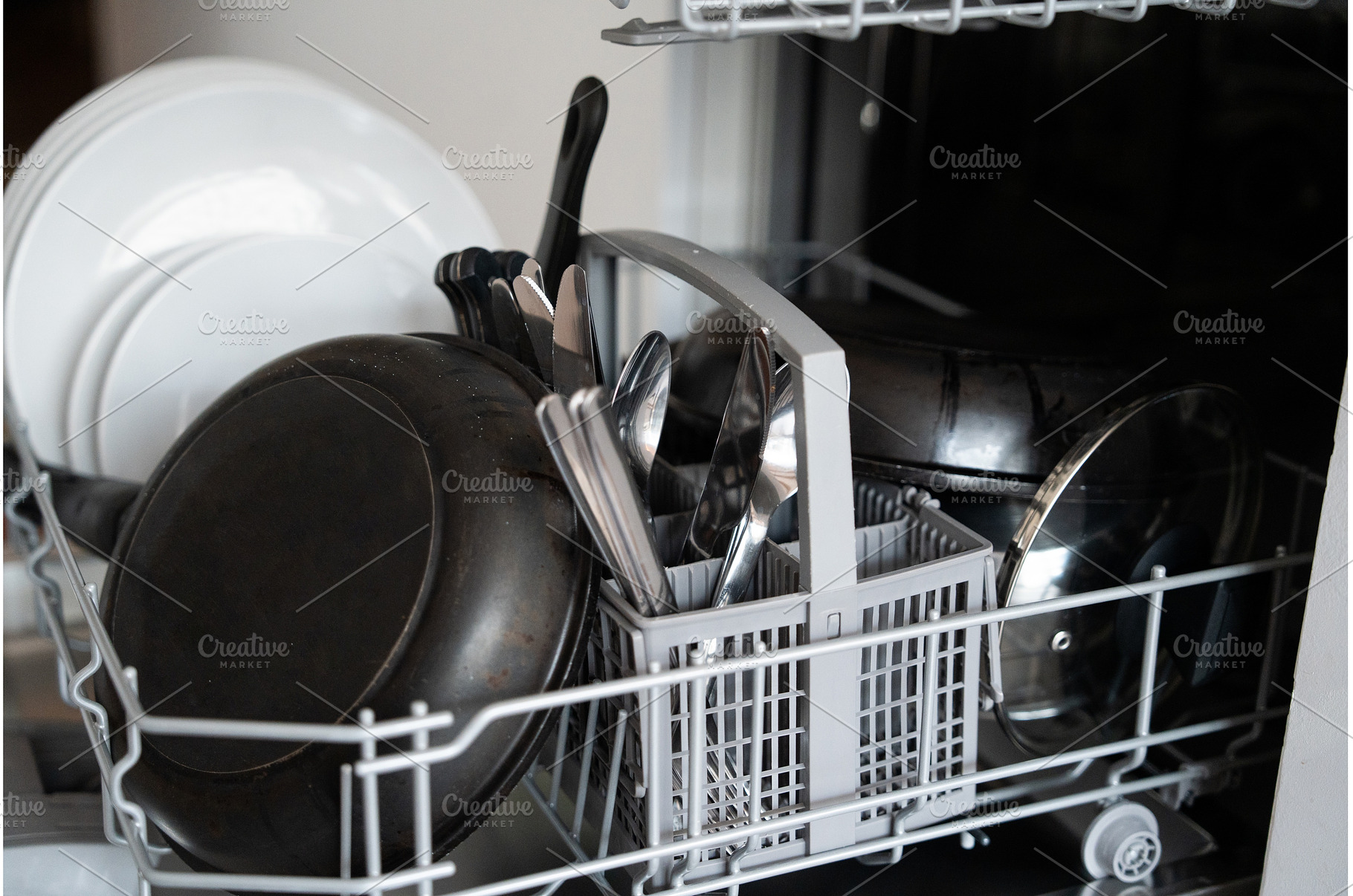 Dishwasher filled with plates, pans, a Technology Photo by volodymyrshtun13795