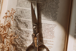 Scissors on craft paper, a Photo by Virgo Studio