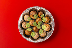 Baked escargot with parsley garlic butter presented in a foil di, a Food & Drink Photo by Ales Munt