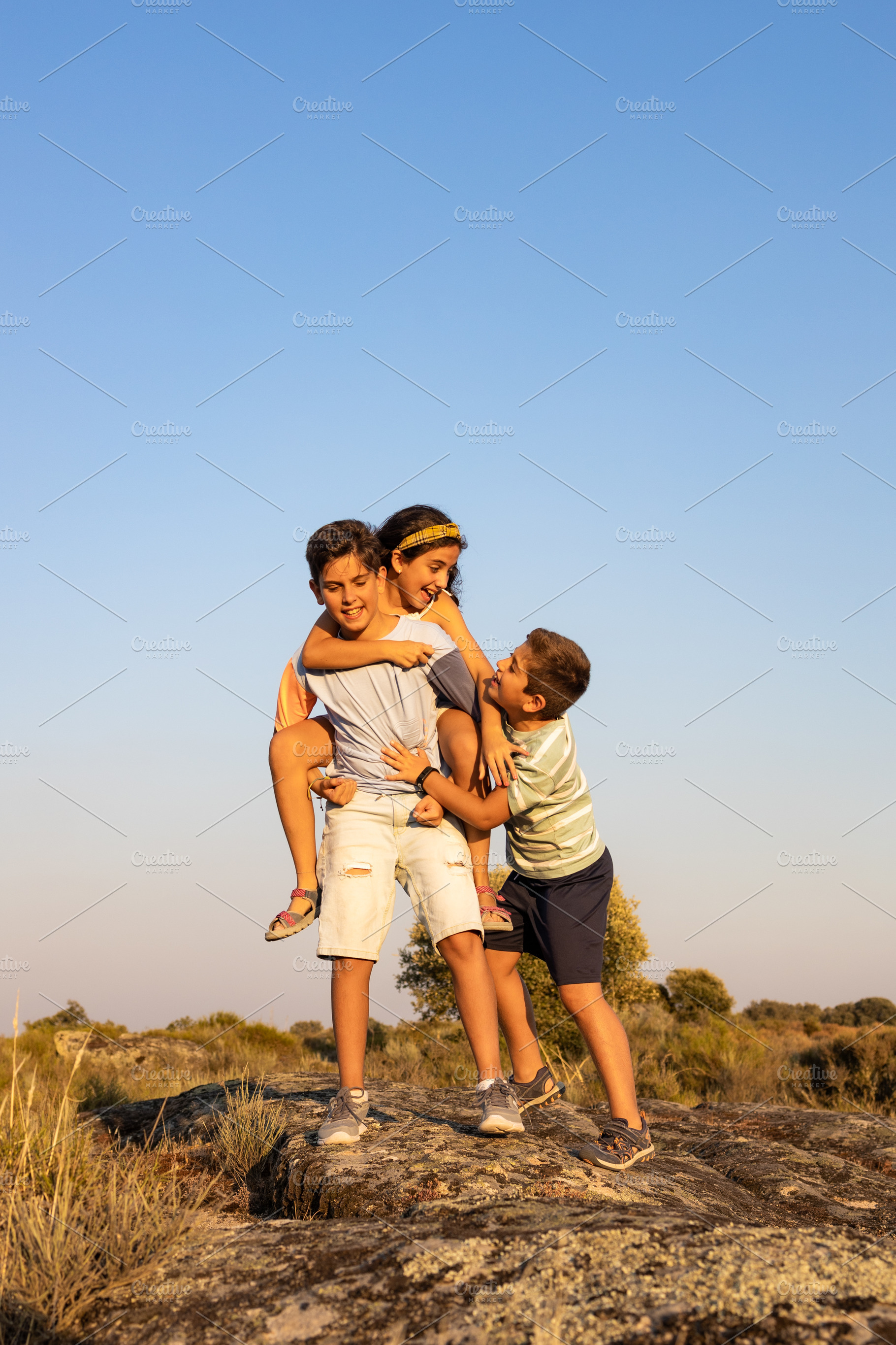 Three funny friends playing ina summer day, a Person Photo by Cosca