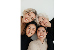 A diverse group of four smiling, a Person Photo by Sergey Kotenev