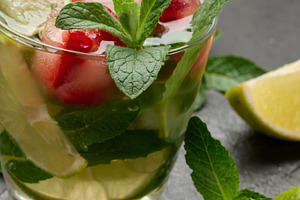 Refreshing mojito cocktail with lime, mint, strawberry, and ice, a Food & Drink Photo by ndanko